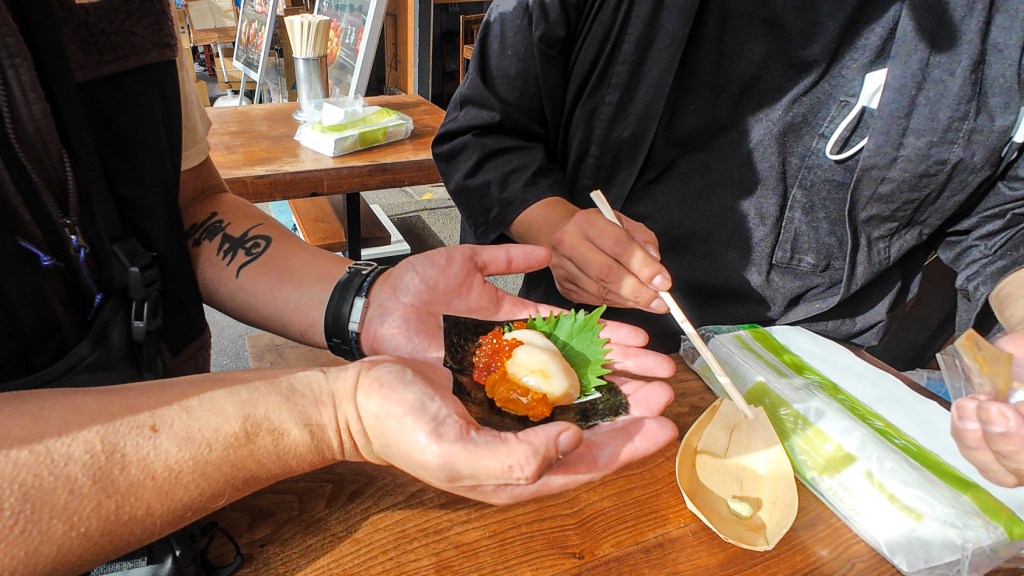 Sashimi hand roll scallop uni ikura salmon roe nori Tsukiji Market Tokyo Japan fresh seafood