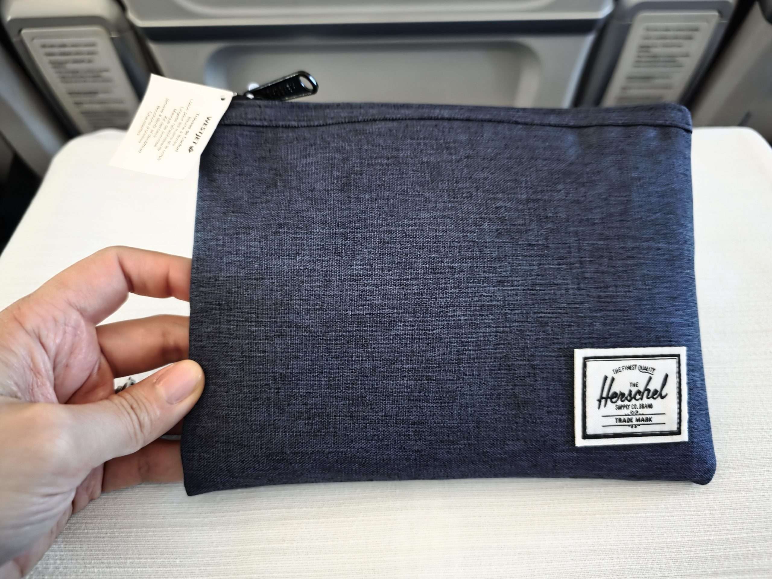 WestJet Premium Economy Herschel amenity kit bag long haul flight Calgary Seoul