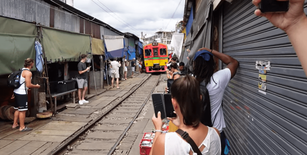 Maeklong Train Market Bangkok day trip — train passing through market stalls