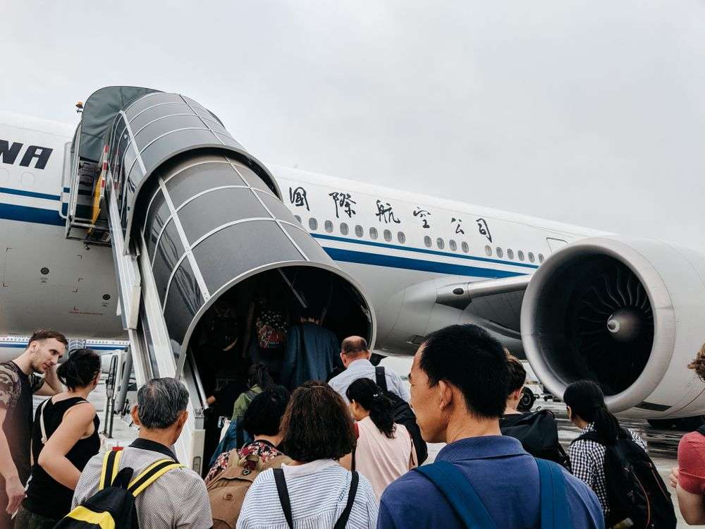 Passengers boarding a plane at Beijing Airport